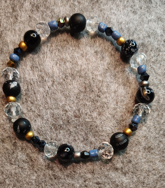 Handmade stretchy bracelet. Black, blue, gold, silver & clear beads