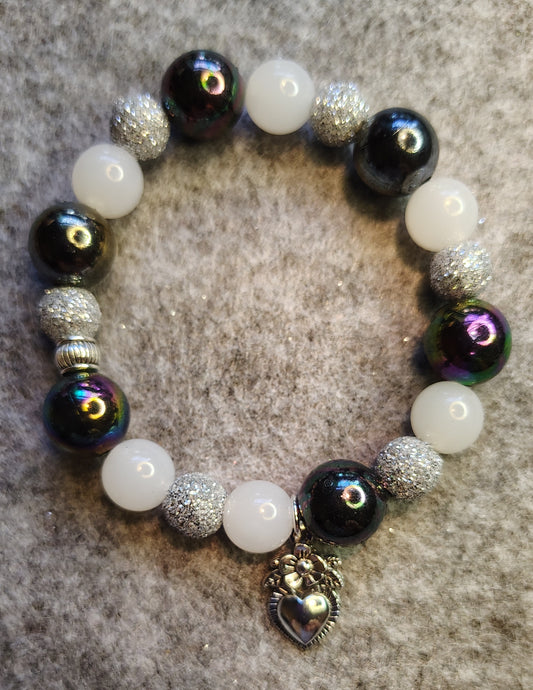 Handmade stretchy bracelet with black, silver glitter and white bead. Heart charm/silver